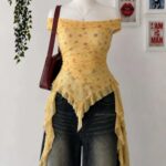 A yellow floral print off-the-shoulder top with ruffled edges displayed on a mannequin.