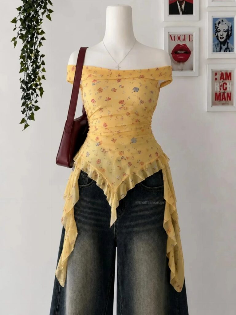 A yellow floral print off-the-shoulder top with ruffled edges displayed on a mannequin.
